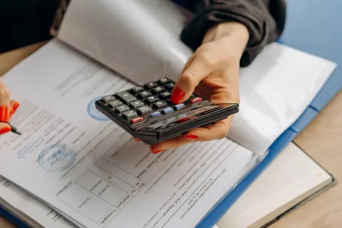Person using a calculator to compare costs