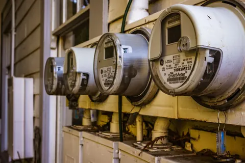 Row of residential electricity meters on an exterior wall